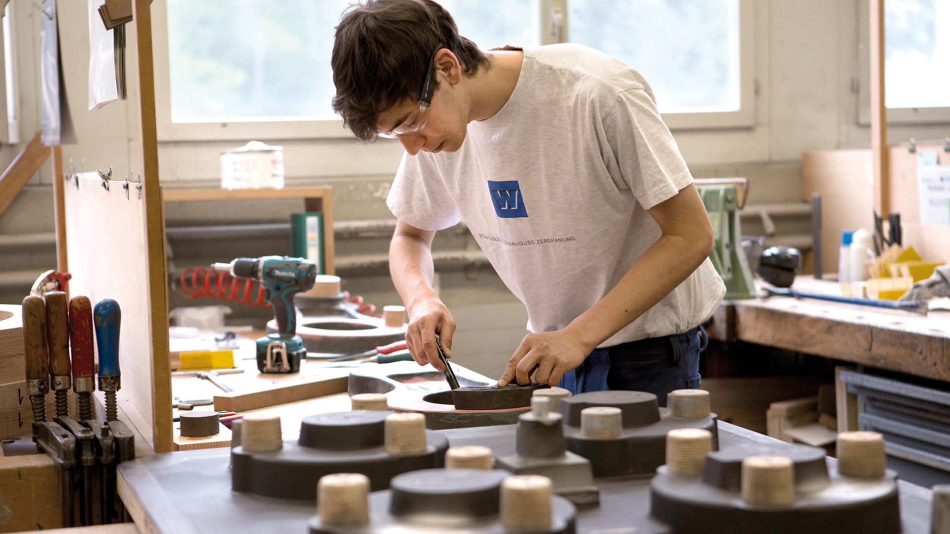 Ein Mann stellt in einem Atelier eine Form her.